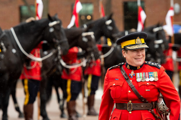 Photo of RCMP Commissioner Brenda Lucki with RCMP officers in background - systemic racism article